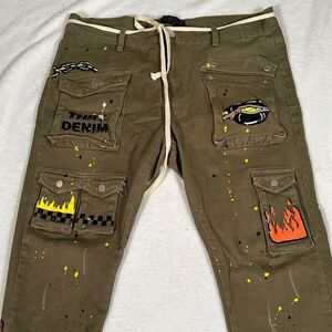 THRT green cargo jeans with a snake graphic and paint splatter details.
